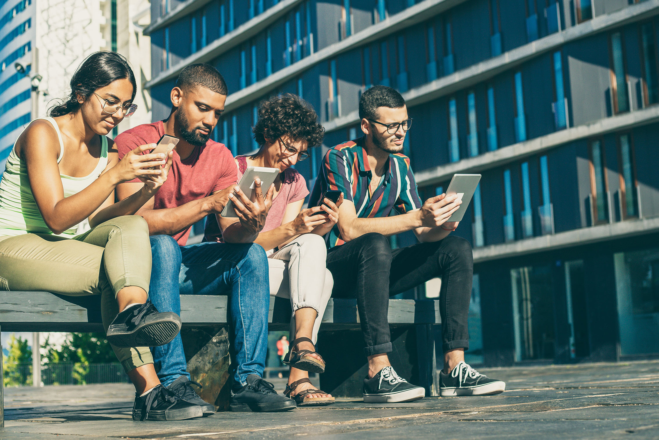 Background photo with students interacting  with their devices.